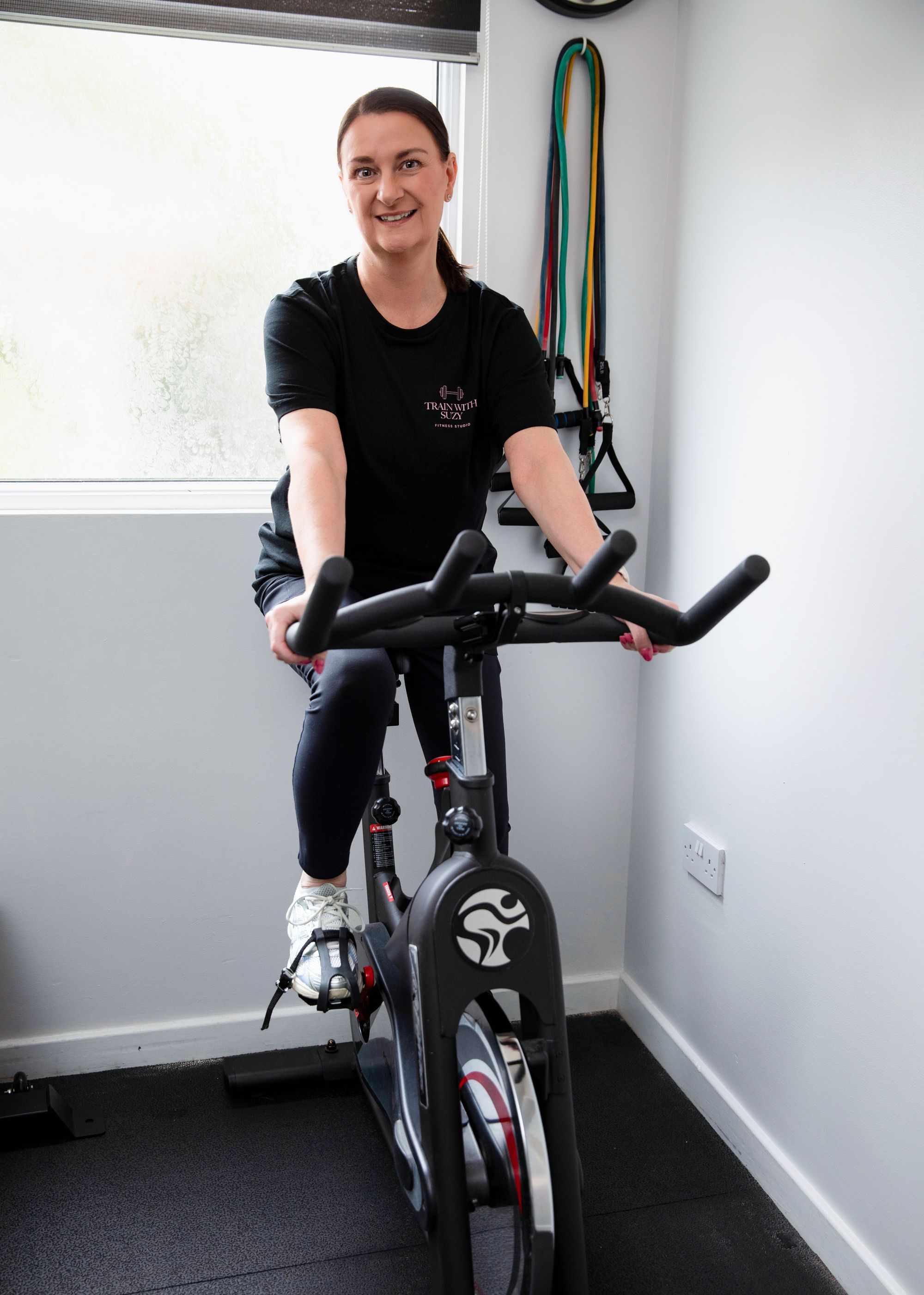 Spin bike and resistance bands in Suzy's fully equipped private gym